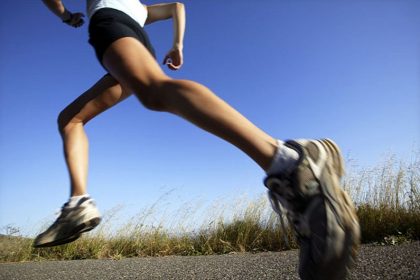 Woman jogging on road, California, USA