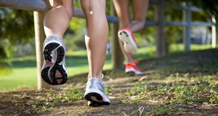 Two Woman Running by fence