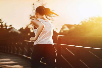 Beautiful jogger crossing bridge